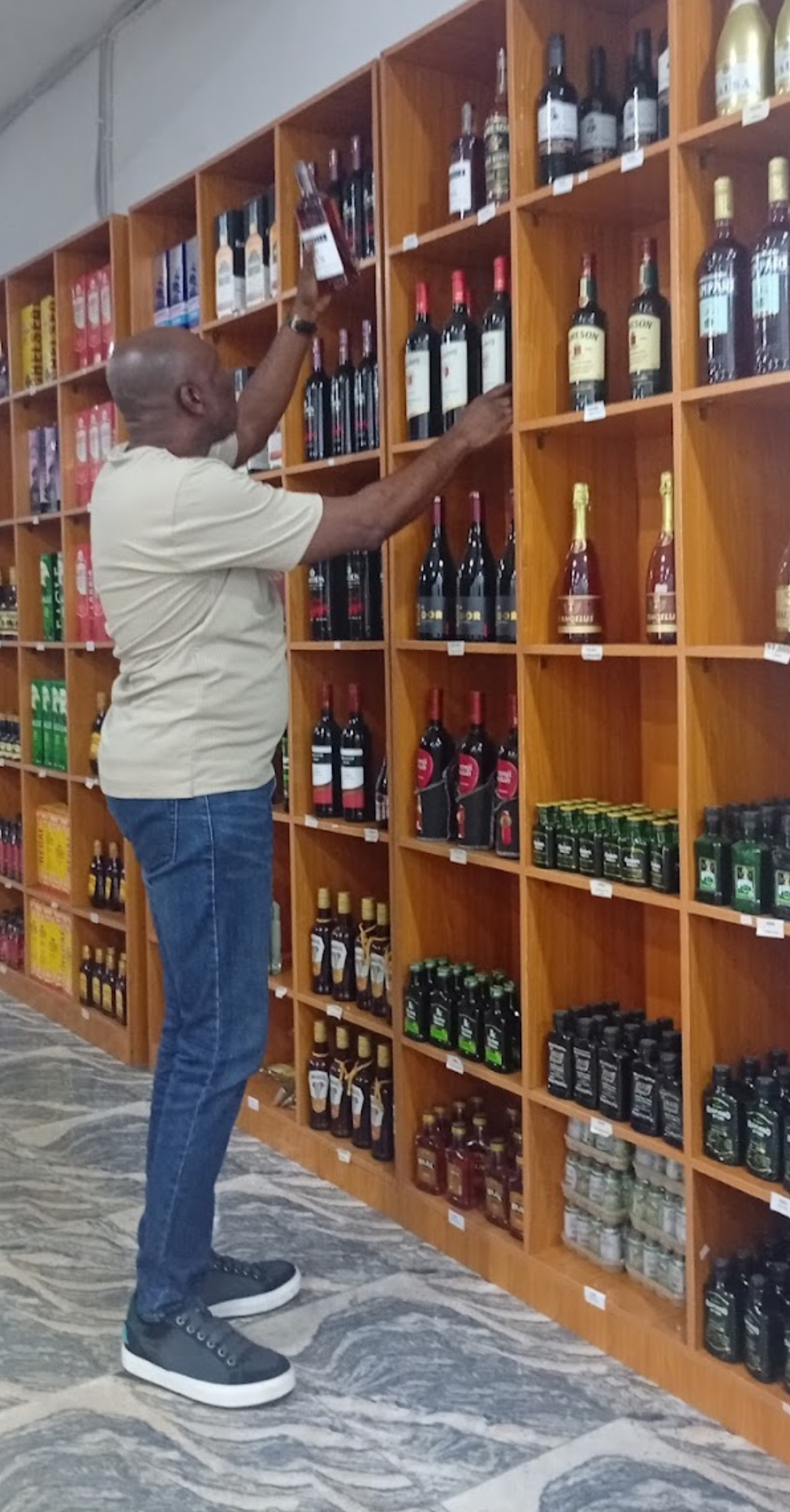 Customer browsing the wine rack